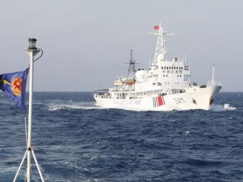 Một tàu hải cảnh Trung Quốc gần giàn khoan, phía trái là cờ của lực lượng tuần duyên Việt Nam. Ảnh chụp ngày 14/05/2014. REUTERS/Nguyen Ha Minh