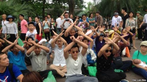 Mọi người ngồi toạ kháng trước UBND TP Hà Nội. Ảnh: DLB