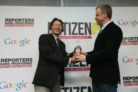 Blogger Huỳnh Ngọc Chênh (trái) nhận giải thưởng Netizen từ ông Christophe Deloire, Tổng thư ký tổ chức Phóng viên Không Biên Giới hôm 12/3/2013 tại Paris. Ảnh: AFP