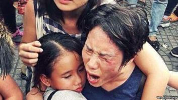 Bà Hoàng Mỹ Uyên ôm con gái trong vụ xô xát giữa lực lượng an ninh Việt Nam với người biểu tình hôm 8/5 ở Sài Gòn. Ảnh chụp màn hình.